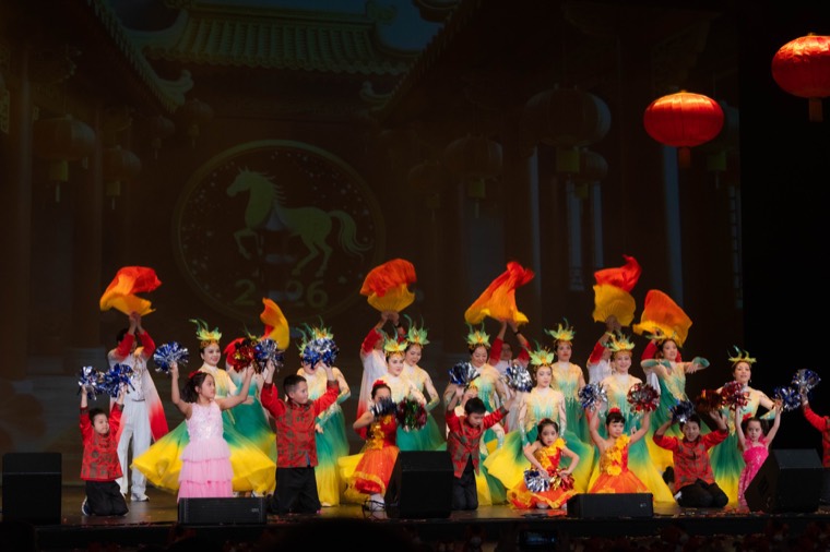 Adults and young performers share a colorful finale