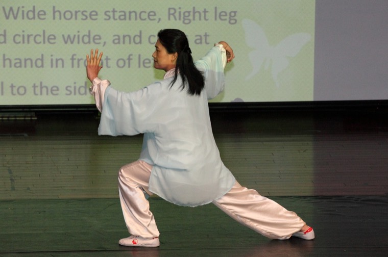 Community members practice Tai Chi together
